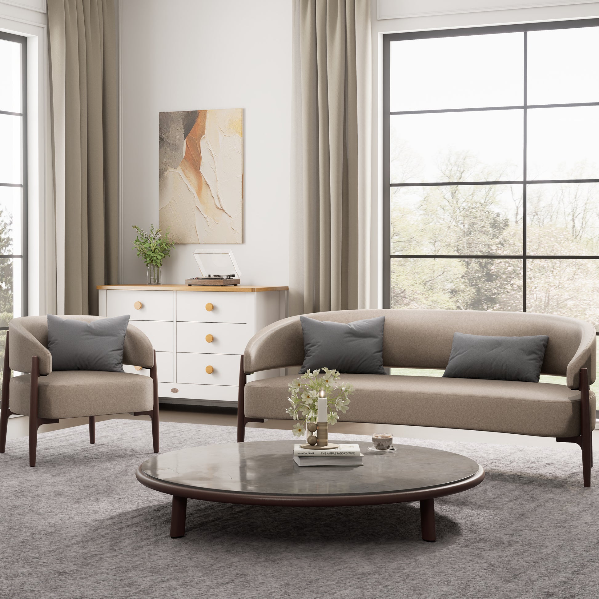 Modern living room with beige sofa, armchair, and round coffee table.
